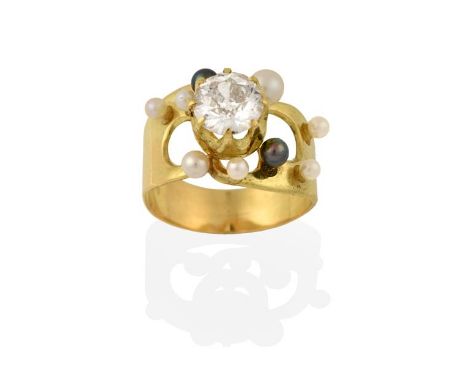 An 18 Carat Gold Diamond and Cultured Pearl Ring, the raised round brilliant cut diamond in a yellow claw setting, to a plain