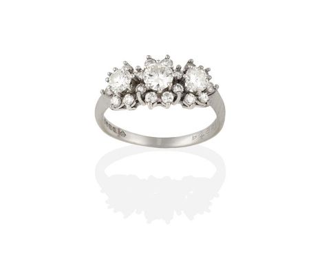 An 18 Carat White Gold Diamond Triple Cluster Ring, graduated round brilliant cut diamonds within borders of smaller round br