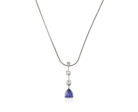 A Tanzanite and Diamond Pendant on Chain, three graduated round brilliant cut diamonds spaced by white knife edge bars, suspe