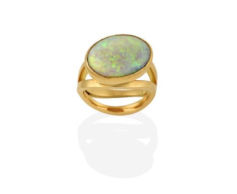 An 18 Carat Gold Opal Ring, the oval cabochon opal in a yellow rubbed over setting, to a double row undulating shank, finger 