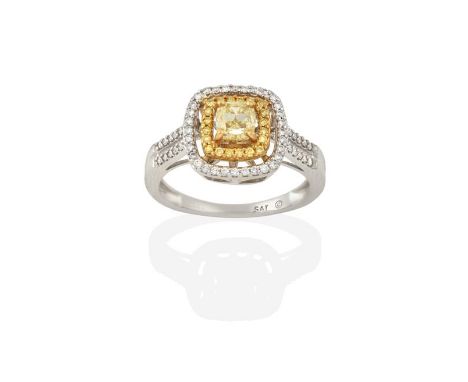 A Diamond Cluster Ring, the cushion cut yellow diamond within a spaced border of round brilliant cut yellow diamonds, in yell