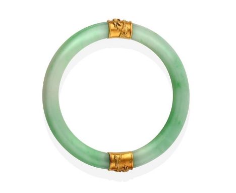 A Jade Bangle, with two bands overlaid with dragon detailing, measures 7.1cm inner diameter .  The bangle is in good conditio