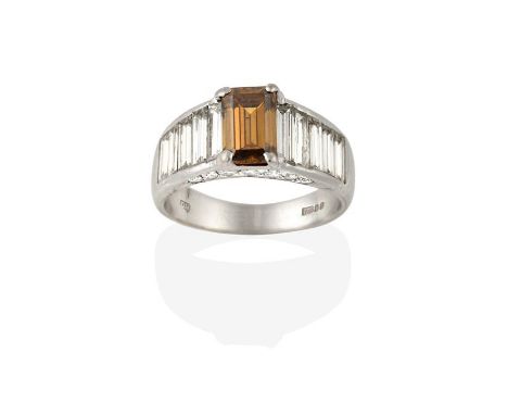 An 18 Carat White Gold Diamond Ring, by David Morris, an emerald-cut brown diamond flanked by white graduated baguette cut di