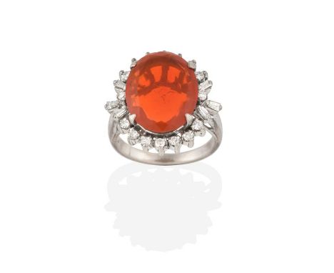 A Fire Opal and Diamond Cluster Ring, the oval cut fire opal within a border of eight-cut diamonds with tapered baguette cut 