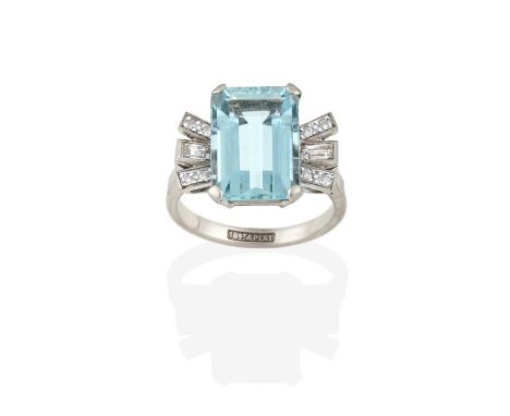 An Aquamarine and Diamond Ring, the emerald-cut aquamarine flanked by baguette cut and eight-cut diamonds, in white claw and 