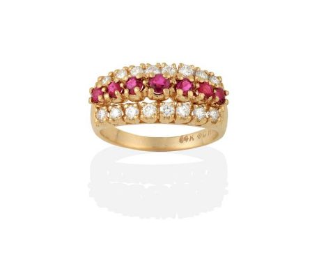 A Ruby and Diamond Ring, the graduated row of round cut rubies flanked by rows of round brilliant cut diamonds, in yellow cla