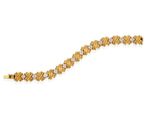 A Diamond Bracelet, twelve round brilliant cut diamond set kite-shaped links, in white pavé settings, alternate with yellow p