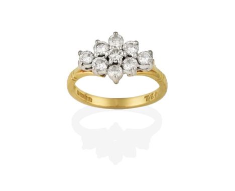 An 18 Carat Gold Diamond Cluster Ring, the round brilliant cut diamonds in white claw settings, to a yellow tapered shoulder 
