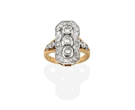A Diamond Ring, three round brilliant cut diamonds in white rubbed over settings, to a spaced border of pavé set round brilli