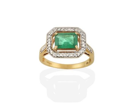 A 9 Carat Gold Emerald and Diamond Cluster Ring, the emerald-cut emerald in a yellow claw setting, within a spaced border of 