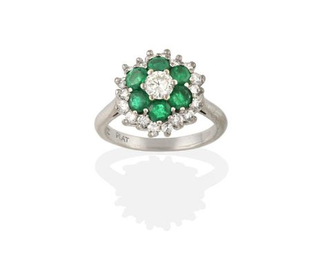 An Emerald and Diamond Cluster Ring, the round brilliant cut diamond within a border of round cut emeralds, to a further bord