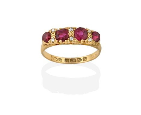 An 18 Carat Gold Ruby and Diamond Ring, four graduated round cut rubies spaced by rose cut diamond accents, in yellow claw se