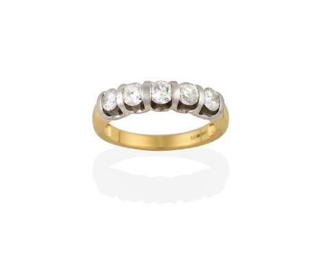 An 18 Carat Gold Diamond Five Stone Ring, the round brilliant cut diamonds spaced by white plain polished bars, to a yellow t