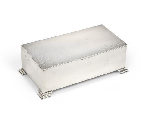 An Elizabeth II Silver Cigarette-Box, by Henry Clifford Davis, Birmingham, 1960, oblong and on four stepped feet, the hinged 
