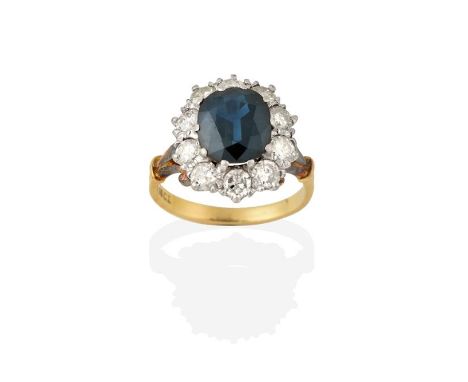 A Sapphire and Diamond Cluster Ring, the oval cut sapphire within a border of round brilliant cut diamonds, in white claw set