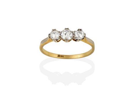 A Diamond Three Stone Ring, the graduated round brilliant cut diamonds in white double claw settings, to a yellow tapered sho