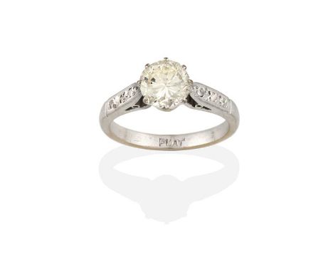 A Diamond Solitaire Ring, the round brilliant cut diamond in a white claw setting, to a rose cut diamond set shoulder plain p