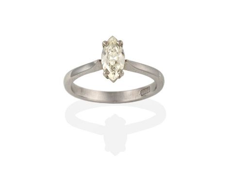 A Diamond Solitaire Ring, the marquise cut diamond in a white claw setting, to a tapered shoulder plain polished shank, estim