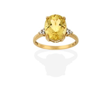 A 9 Carat Gold Heliodor Beryl and Diamond Ring, the oval cut heliodor flanked by trios of round brilliant cut diamonds, in ye
