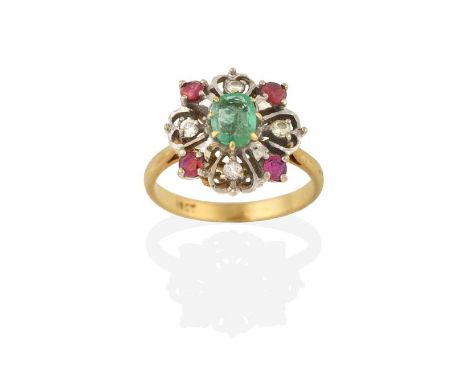 An Emerald, Ruby and Diamond Ring, the oval cut emerald in a yellow claw setting, within a white openwork border set througho