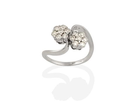An 18 Carat White Gold Diamond Double Cluster Twist Ring, the clusters formed of round brilliant cut diamonds, in claw settin