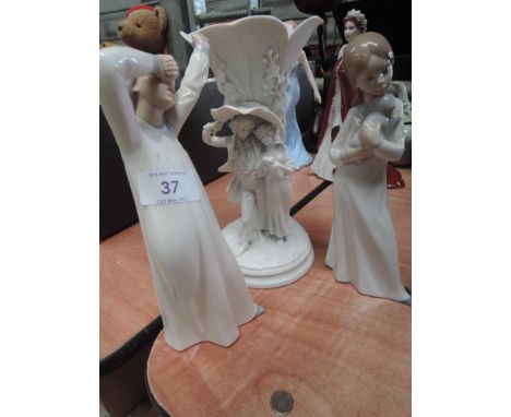 Two Nao figurines and a resin vase