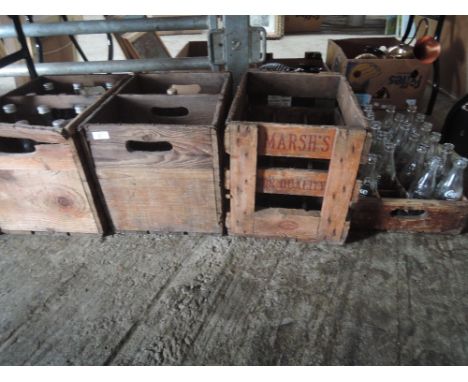 A selection of vintage crates and bottles including Coca Cola and Marsh's of Barrow