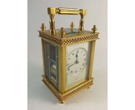 A 19th century French gilt brass carriage clock with repeater by Edward of Glasgow - 15.5cm tall to top of handle, with leath