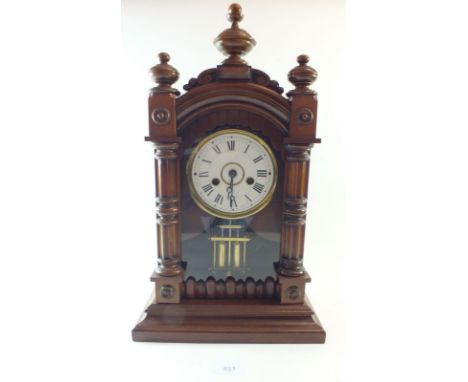 A 19th century walnut architectural style mantel clock with striking movement and compensated pendulum