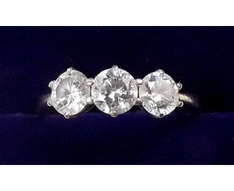 An 18 carat white gold three stone diamond ring - the centre stone 1/2 carat - size 0