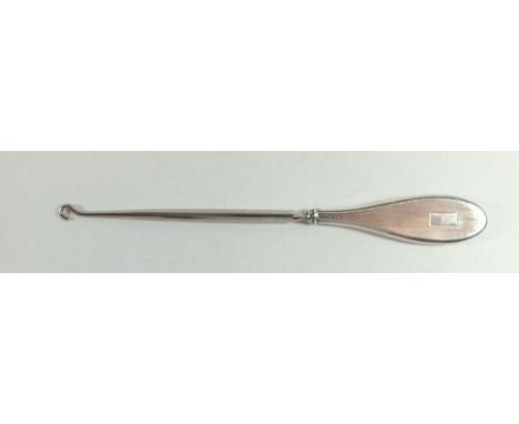 A silver handled button hook with engine turned decoration - 24cm, Birmingham 1930