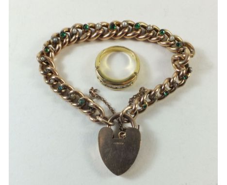 A gold plated bracelet with links set in green stones and seed pearls, together with a yellow metal and clear stone ring.