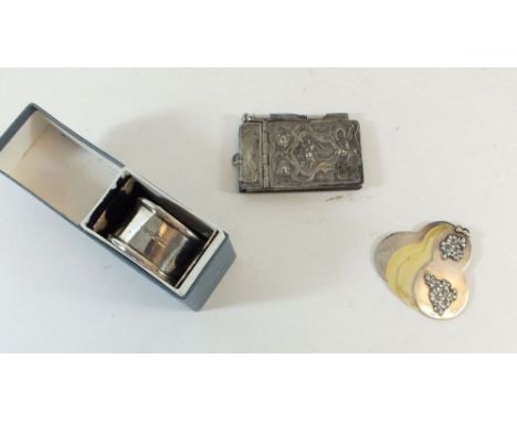 An Art Nouveau silver plated notepad, a white metal and ivory Edwardian chatelaine notepad and a silver napkin ring