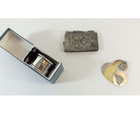 An Art Nouveau silver plated notepad, a white metal and ivory Edwardian chatelaine notepad and a silver napkin ring