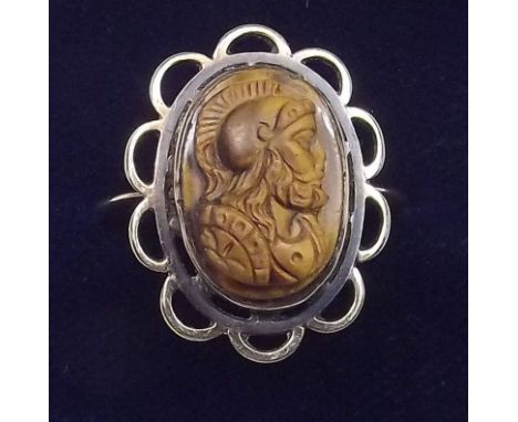 An antique yellow metal ring with carved tigers eye cameo - size N/O