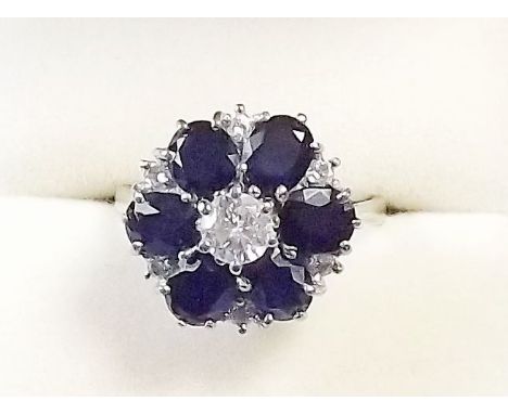 An 18 carat white gold diamond and sapphire cluster ring