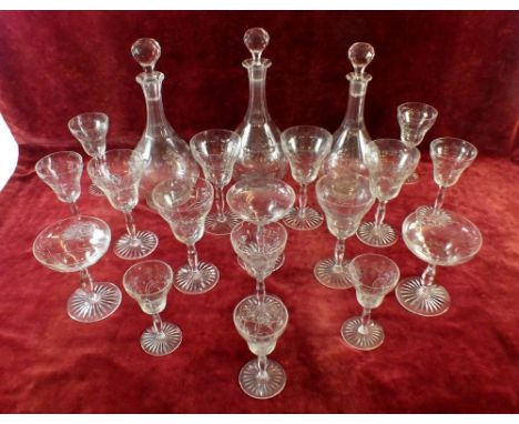 A large suite of French glassware with an engraved floral Art Nouveau decoration consisting of: three decanters, six large an