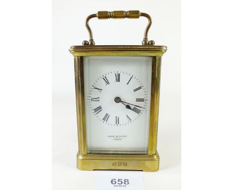 A small late 19th/early 20th century brass travelling carriage clock by John Walker of London - 11cm tall not including handl