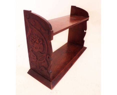 A Victorian two tier carved wall shelf with carved Arts and Crafts stylised floral decoration to sides - 51cm wide