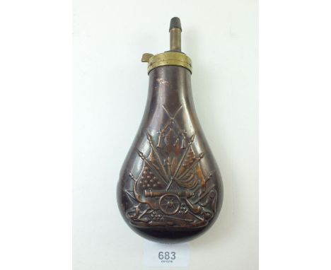 A Victorian copper powder flask with embossed decoration of cannon and flags