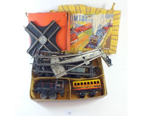 A Brimtoy tin plate O gauge train set comprising train, tender, 'First Class' coach, truck and track - boxed, with a Hornby C