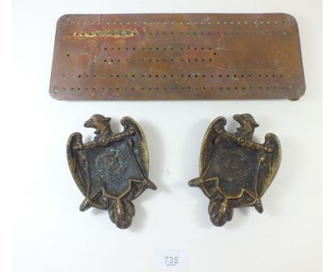 Two brass Imperial Eagle ashtrays and a cribbage board