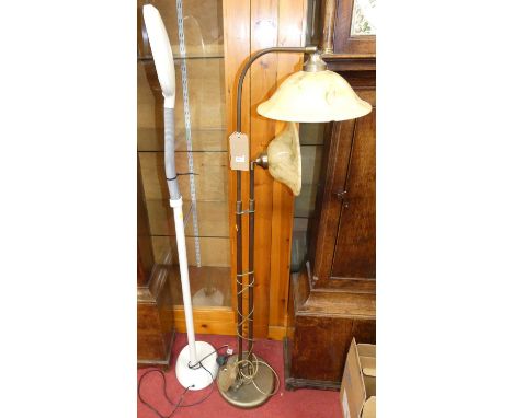 A contemporary brushed brass twin floor light; together with a contemporary white finished adjustable floor light (2)
