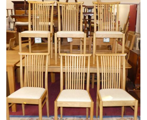 A contemporary Ercol blond oak dining suite, comprising; round cornered extending dining table with pull-out action and singl