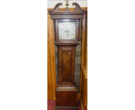A circa 1800 provincial oak longcase clock, having a square painted dial, twin winding holes for an eight-day movement, with 