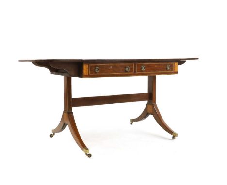 A 19th century mahogany and satinwood crossbanded drop flap two-drawer sofa table, raised on outswept supports to brass cap c