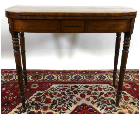 A Regency mahogany D-end and ebony inlaid fold-over card table, with rear gateleg action, raised on ring turned supports to c