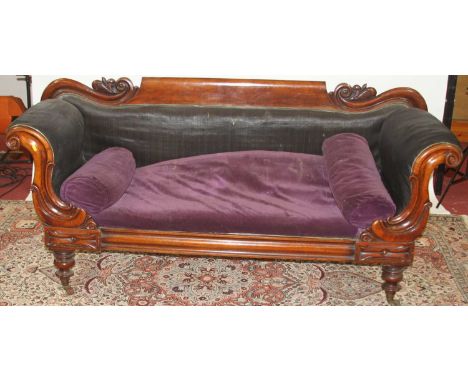 A mid-Victorian mahogany show frame three-seater scroll end sofa, raised on squat turned supports to castors, width 205cm