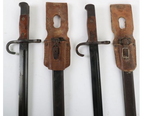 2x WW2 Japanese Type 30 Arisaka Bayonets, both having wooden grips and housed in steel scabbards. Both bayonets with down tur