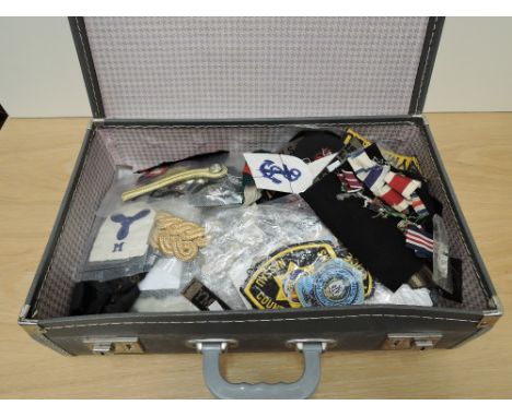 A collection of Military related Cloth Badges, Epaulettes etc, many items seen, in travel case